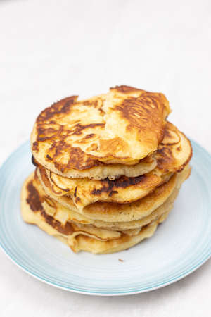 Top view of stacked pancakes served on the plate.