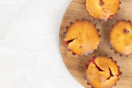 Cherry Cup Cakes served on the plate above white background.