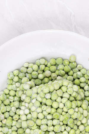 Frozen Green Peas on the white plate.の写真素材
