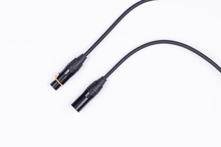 Audio guitar and microphone cable isolated above white background