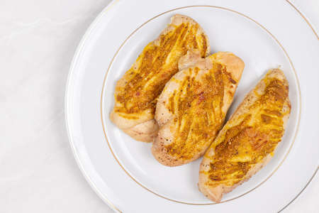 Fried Chicken Breasts with mustard and cheese.