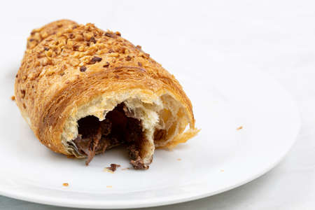 Croissant with chocolate on the plateの写真素材