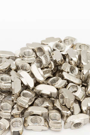 Aluminum nuts for cnc construction. Cnc machine parts above white background