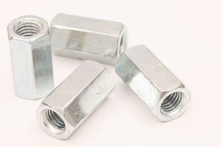Metal extended nuts isolated above white background.