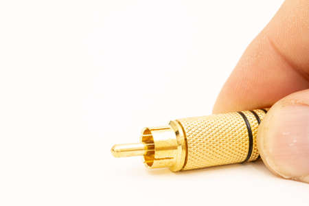 Golden stereo rca connector isolated above white background.の写真素材