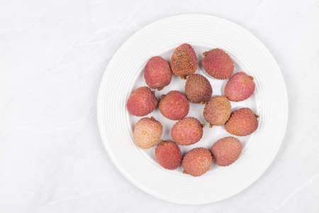 Lychee fruit isolated above white background.の写真素材