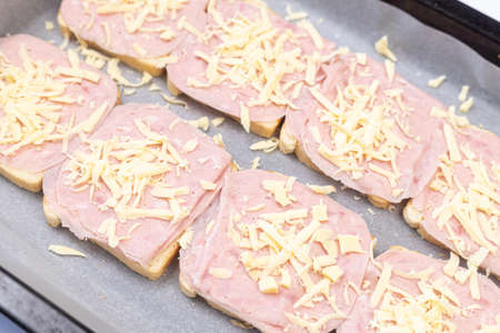 Baked Sandwiches with ham and cheese on the baking tray.の写真素材