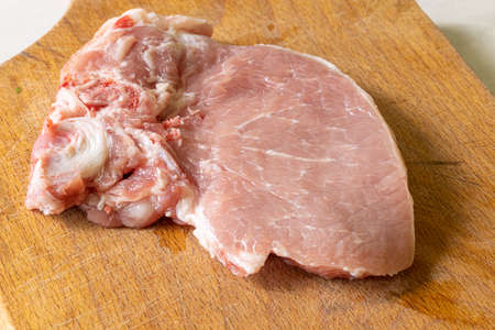 Raw Pork Chops on the wooden cutting board.の写真素材