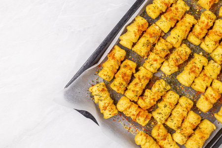Potatoe croquettes on the baking tray ready for baking.