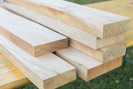 Pile of Beech boards in the warehouse. Raw beech planks on the pileの写真素材