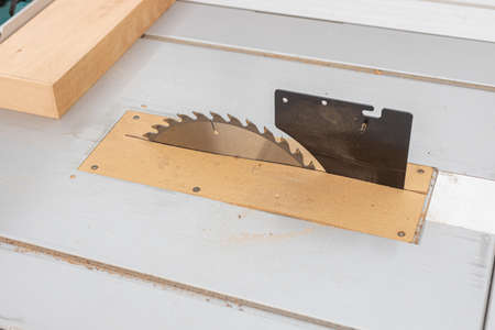 Table saw closeup blade with wood on the table.の写真素材