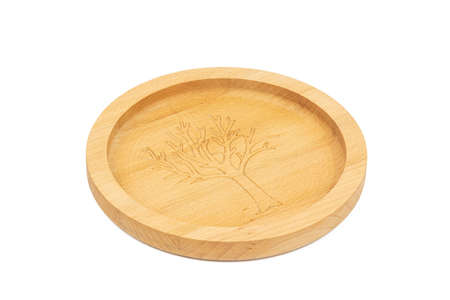 Wooden plate with engraved tree image on the bottom.の写真素材