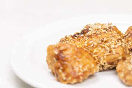 Fried marinated chicken white meat on the white plate.の写真素材