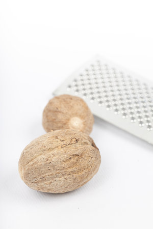 Nutmeg isolated. Whole nut and nutmeg powder isolated on white backgroundの写真素材