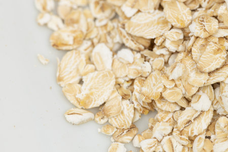Dry rolled oatmeal in bowl isolated on white background. Top viewの写真素材