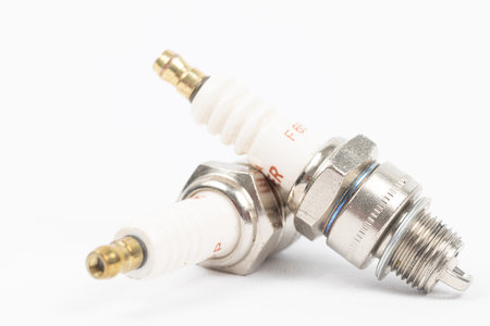 Ignition spark plug with platinum electrode. Automotive parts isolated above white background.の写真素材