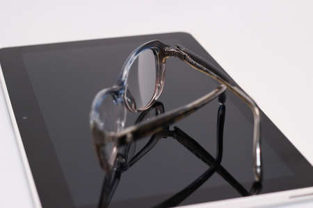 glasses with diopter, and the tablet on white backgroundの写真素材