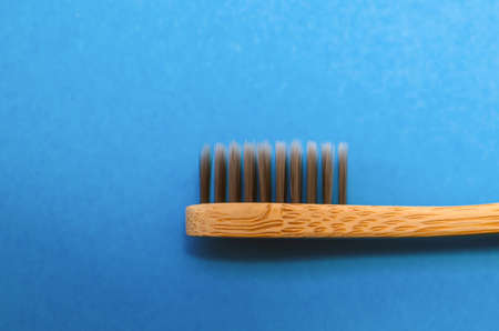 bamboo toothbrush on blue background, close-up.の写真素材