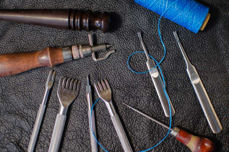 Genuine Leather. Sewing a purse. Leather work. Tools for sewing wallets, clutches. Manual sewing of...