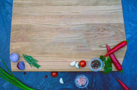 Vegetables and spices vintage border and empty cutting boardの写真素材