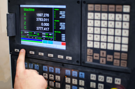 The process of programming a CNC machine. Entering data into a computer controlled machine, starting...