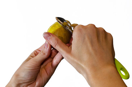 Close up of female hands peeling potatoes isolated on white.