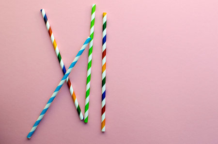 Drinking Straw. Drinking paper colorful straws for summer cocktails on a pink background with copy space.の写真素材