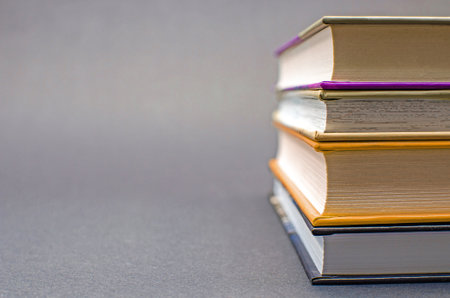 A simple composition of many hardback books on a black background. Back to school. Education concept. Copy space.の写真素材