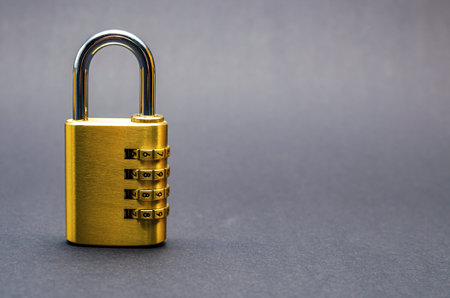Close-up combination lock with chrome numerals on black background.の写真素材