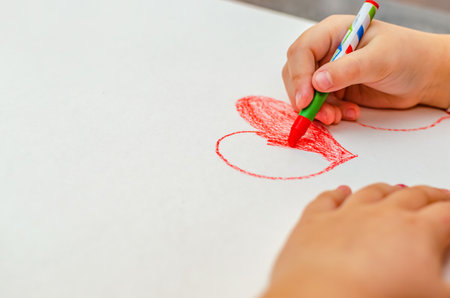valentines day, girl draws heart on paper, copy spaceの写真素材