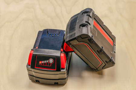 two batteries from a cordless drill with a charge indicator