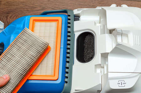 Vacuum cleaner filter with water filter. Large white vacuum cleaner on a brown floor.の写真素材
