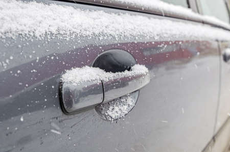 Car door handle in snow, first snow, snowfall, unexpected snowの写真素材