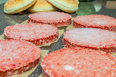 Frozen burger meat on table before grilling, defrost before grillingの写真素材