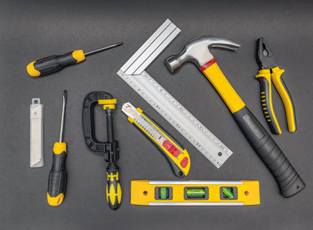 Set of tools. Top view of mechanic tools on black background.の写真素材