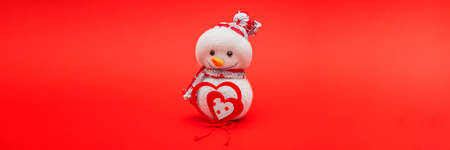 Christmas card, Happy New Year greetings. Snowman on an red background, place for text. Christmas or...
