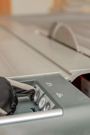 Turns on the woodworking machine, the hand of the carpenter starts the woodworking machine....