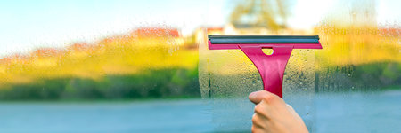 House cleaning. Washing dirty window panes with detergent. wash window glass.の写真素材