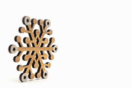 Snowflake on a white background. Wooden snowflakes cast shadow on white isolated background. Printable banner, mockup for christmas card, place for textの写真素材