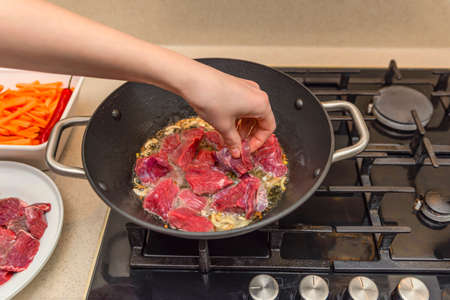 Cooking pilaf in a cauldron. A step by step recipe for cooking pilaf, cut the beef into pieces and...