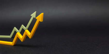 An uptrend, increased sales, or increased value. graphic arrows pointing upwards on black background for banner, design or text insertの写真素材