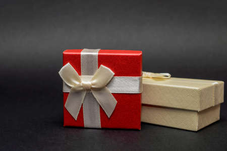 Gift boxes on a black background. Red gift boxes, open box. Postcard for printing, banner with place...