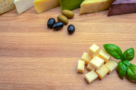 Cheese background. Assortment of different types of cheese on a wooden background.Place for text