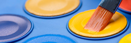 Brush for watercolor painting close-up and a set of watercolor paints. Colorful photography. Selective focus.の写真素材