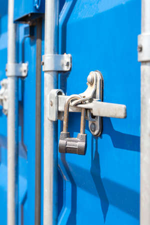 Container close-up. Blue cargo container with a lock. The concept of the increased cost of freight....
