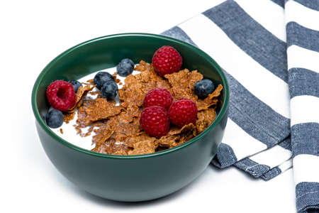 Muesli, isolate on white. Breakfast, healthy food and diet. Muesli with fruits and milk in a plate....