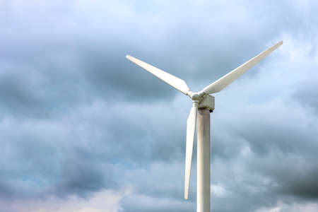 Windmills for electricity generation. Wind turbine against the background of a dark gloomy sky,...