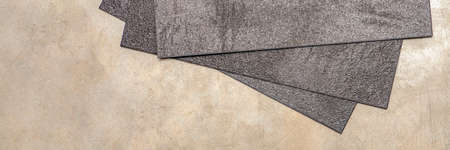 Vinyl PVC floor. The texture of the vinyl floor is black. Samples of vinyl covering, black pvc tiles...