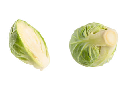 Fresh green Brussels sprouts on a white background. Brussels sprouts cut in half casts a shadow on white isolateの写真素材