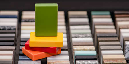 Large selection of stone samples for countertops and floors. Pieces of artificial acrylic stone in a sample box. A set of shades of countertops of different texturesの写真素材